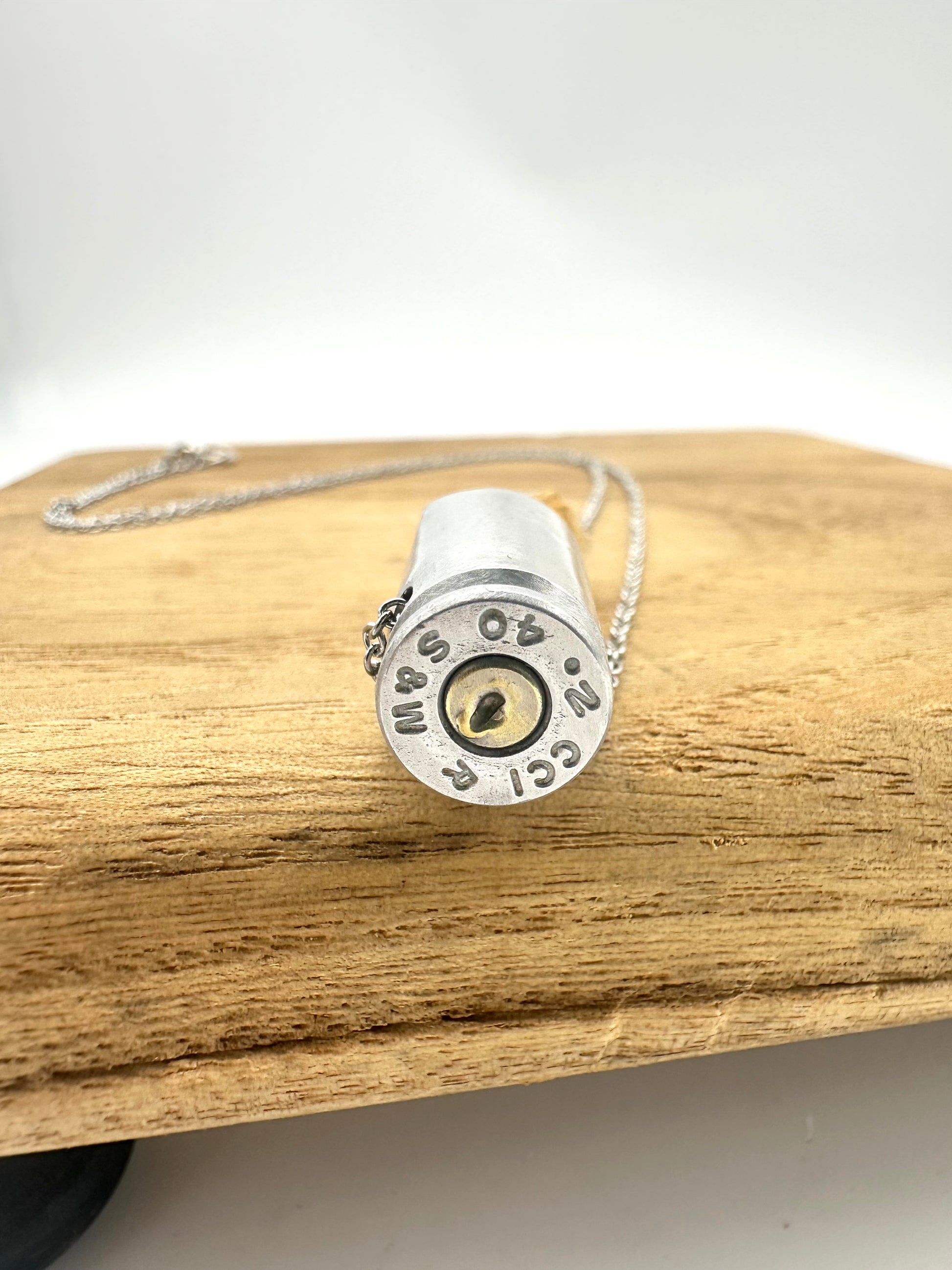 Reclaimed 40cal bullet casing paired with raw citrine point, handcrafted crystal jewelry pendant