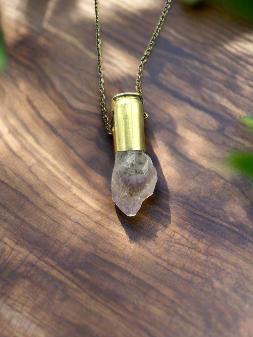 Handcrafted necklace with reclaimed .45 caliber bullet casing and natural amethyst point pendant on 20-inch brass chain