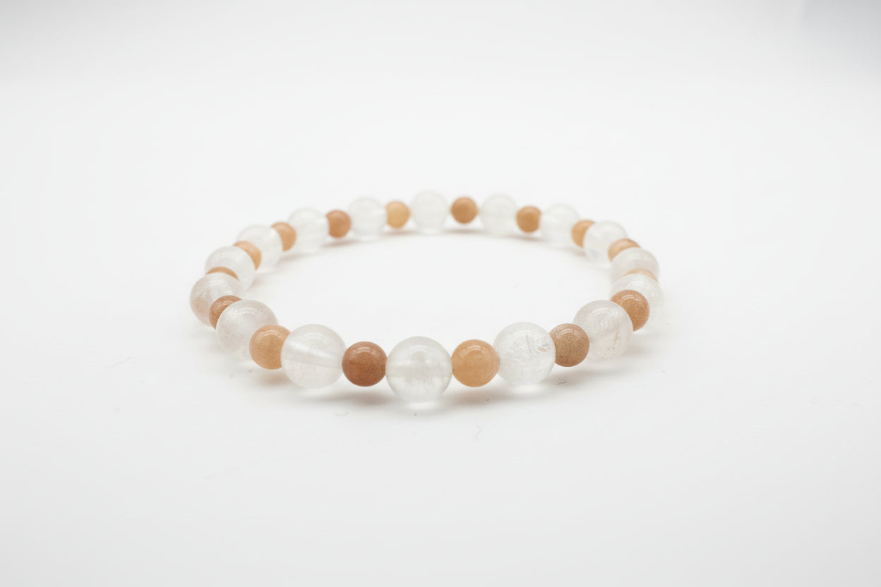 Beaded bracelet with clear and brown beads on a light gray background