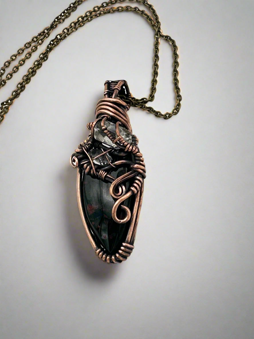 Necklace with a copper pendant on a white background