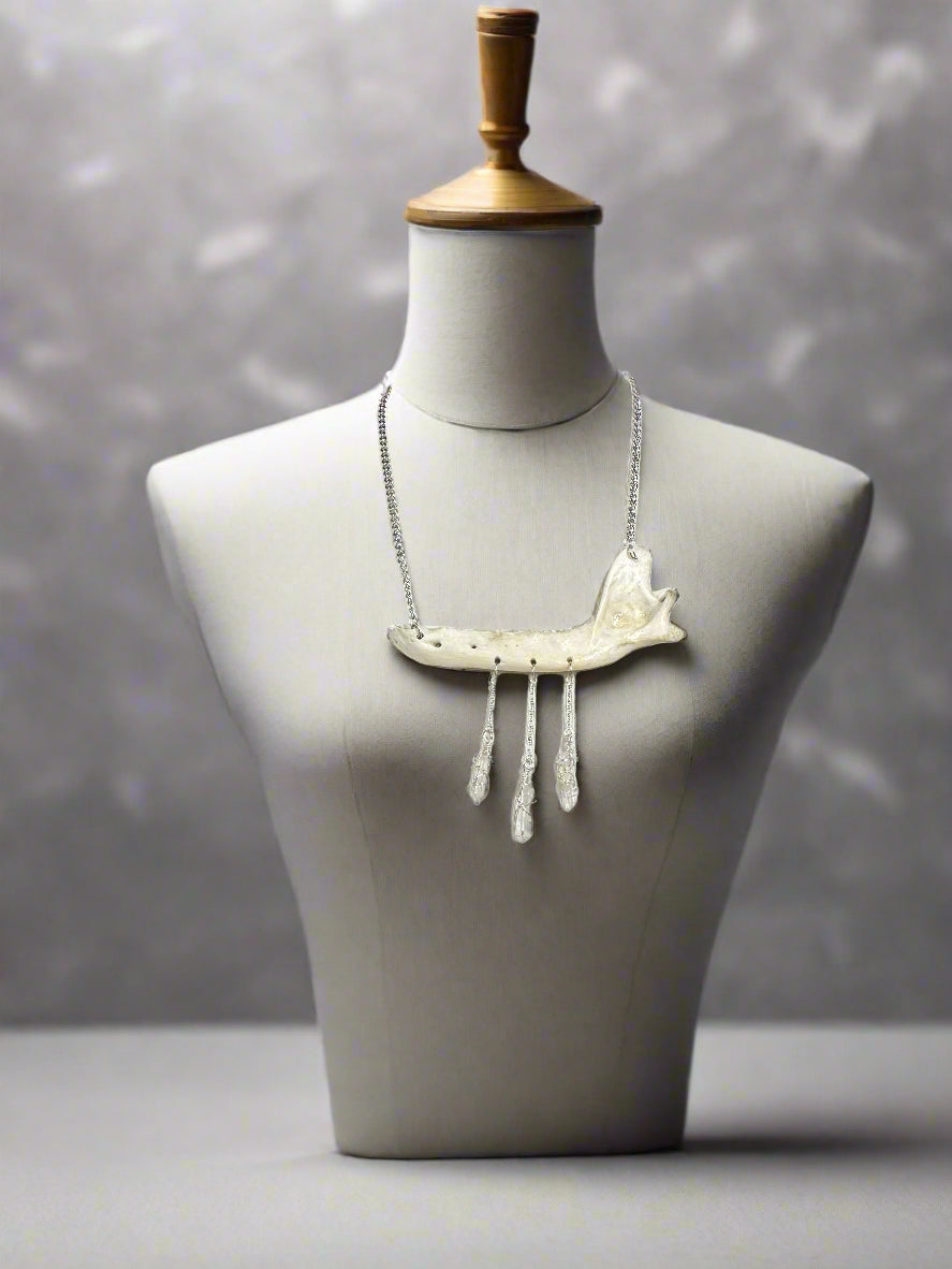 mannequin showcasing fox jaw necklace adorned with quartz crystals