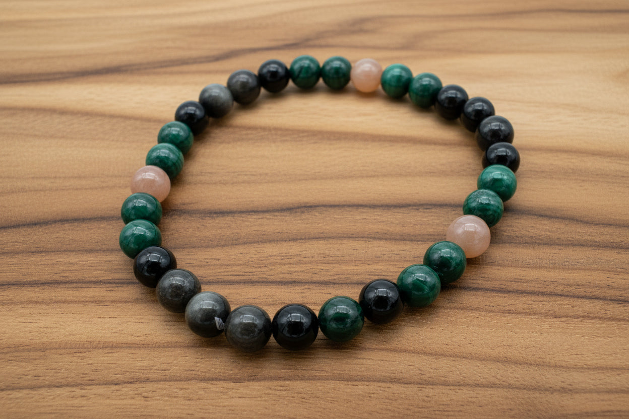 Malachite, onyx, and peach moonstone gemstone bracelet with polished beads