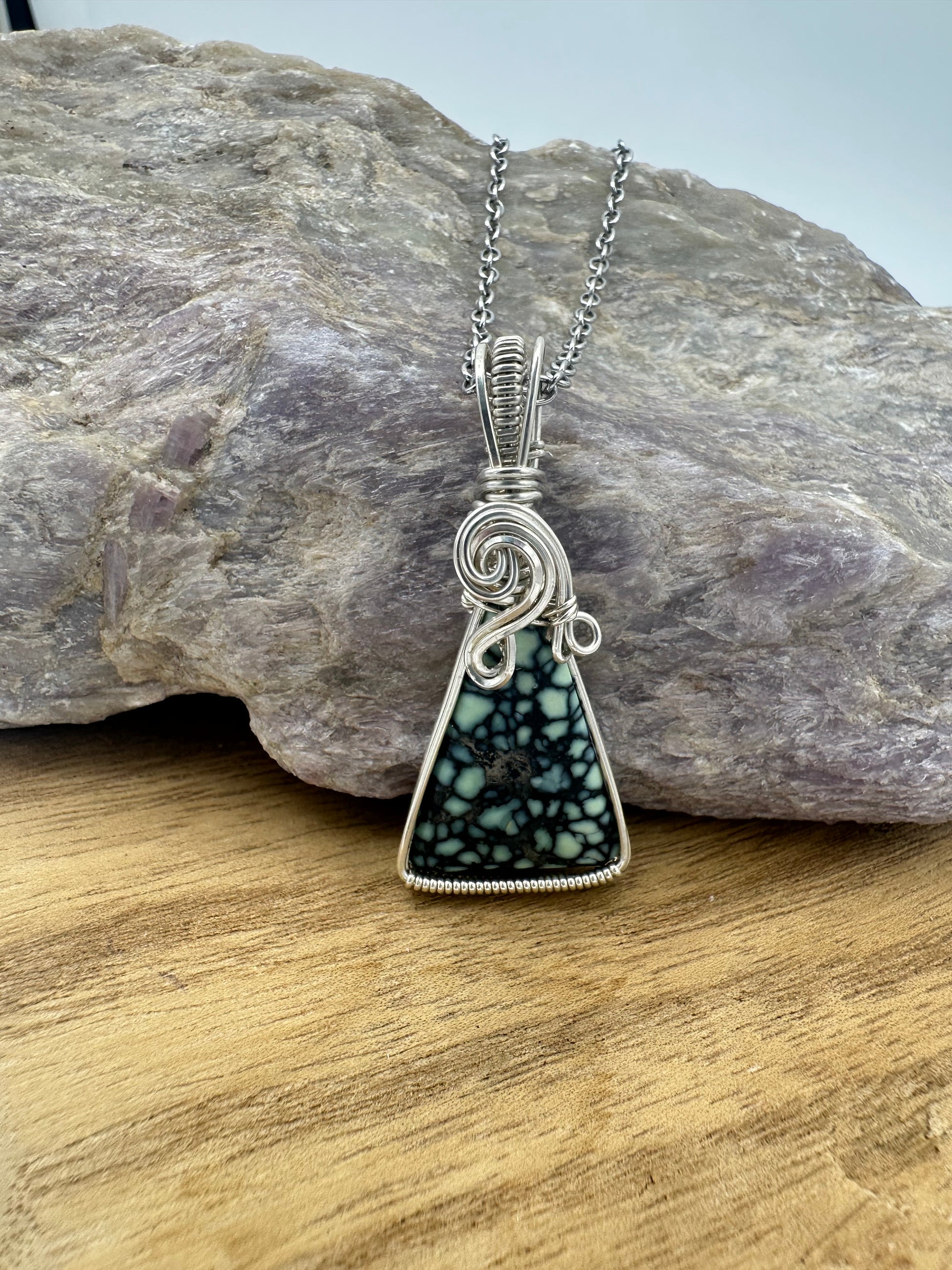Close-up of spiderweb variscite matrix and sterling silver wire wrapping