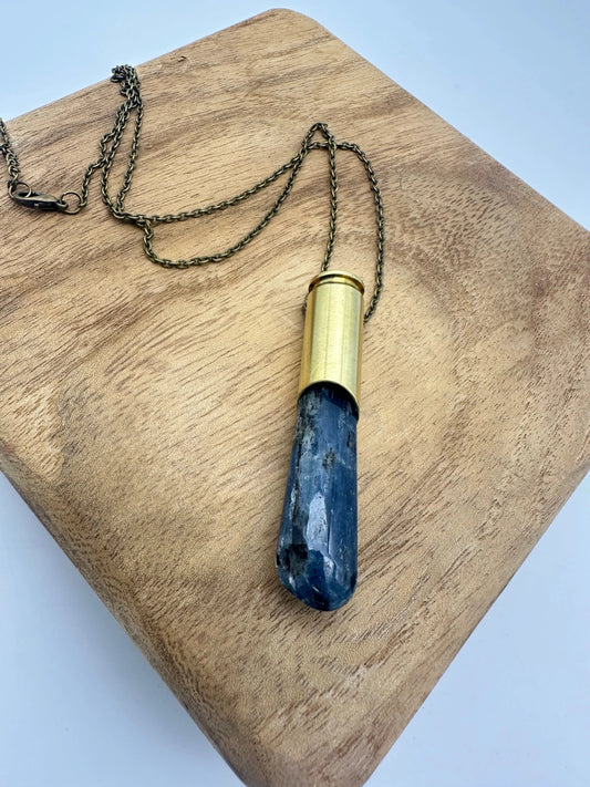 Crystals & Casings necklace featuring upcycled Winchester 6.5 bullet casing and kyanite crystal on long brass chain