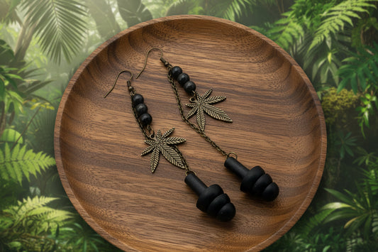 Bronze leaf-shaped earrings with black beads on a light gray background