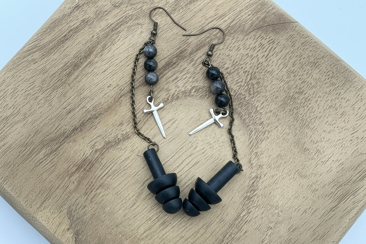 Black beaded bracelet with metal accents on a wooden surface