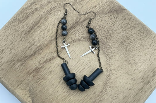 Black beaded bracelet with metal accents on a wooden surface