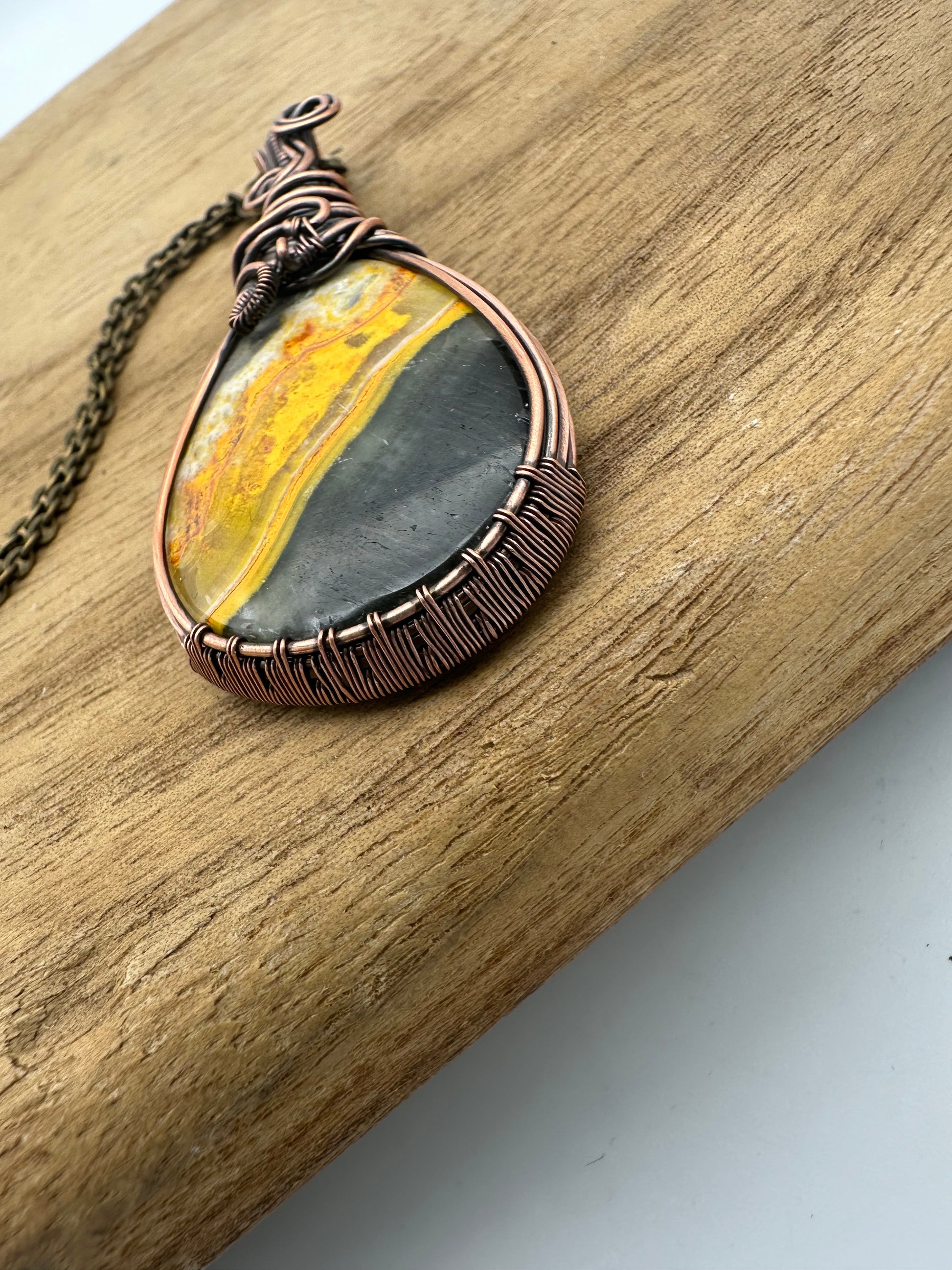 Necklace with a stone pendant on a wooden surface