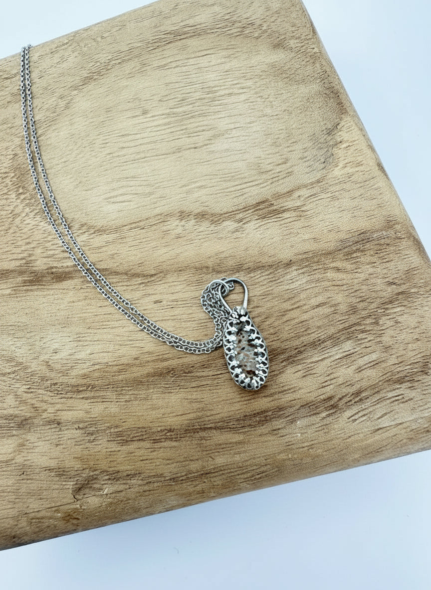 “Full length view of sterling silver deer ribcage bone necklace on 22 inch chain