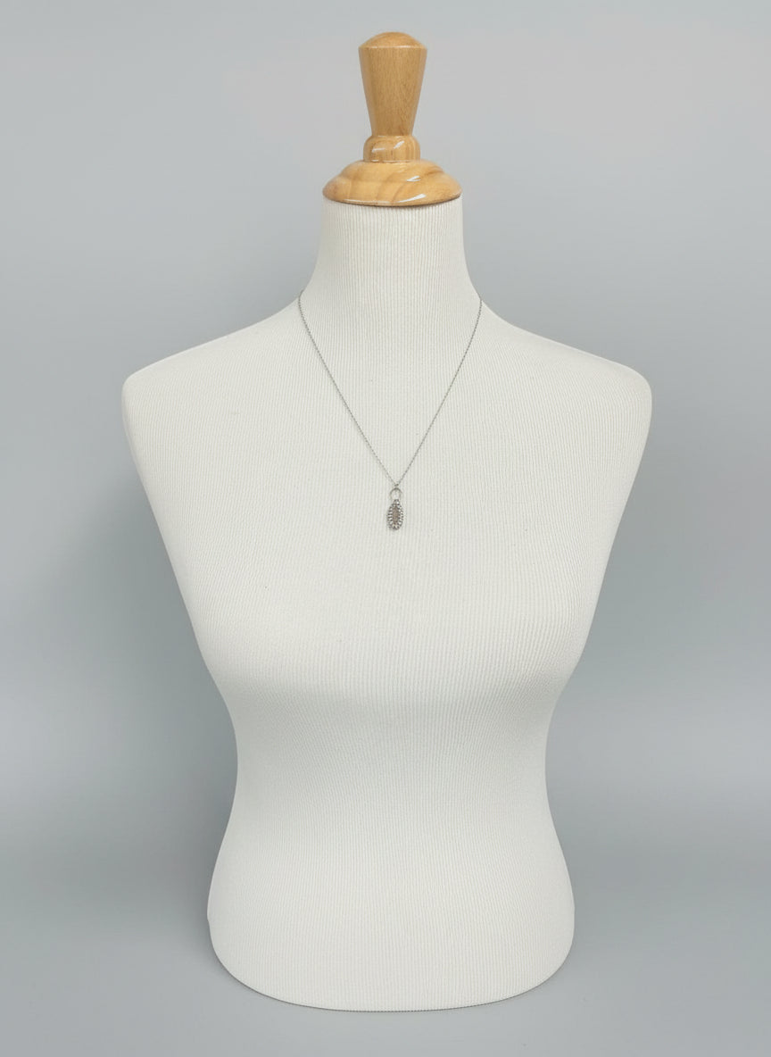 “Deer ribcage bone pendant set in sterling silver displayed on necklace bust with 22 inch chain