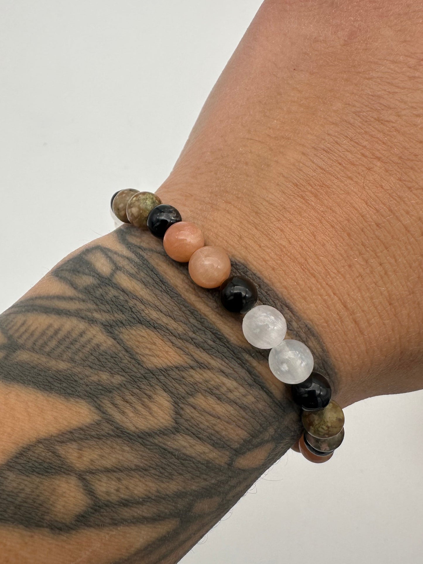 Bracelet with beads on a wrist with tattoos