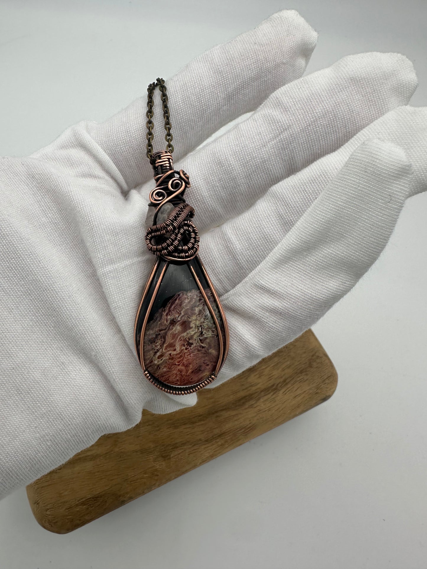 Petrified palm root pendant hand wrapped in copper wire showing natural grain
