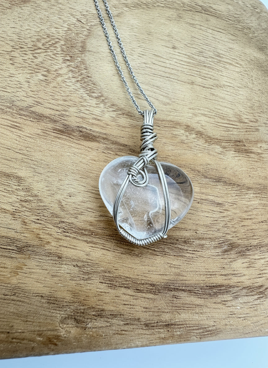 Front view of sterling silver wrapped quartz heart pendant on 18 inch chain